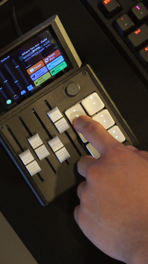 Finger pressing a macro key on the Mixlar M1X
