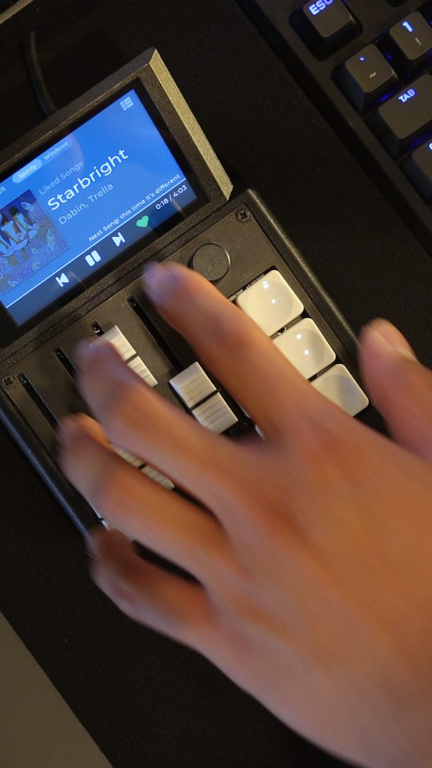 The M1X touchscreen showing a now-playing track with artwork