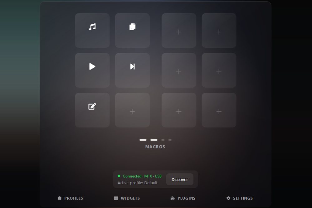 The Mixlar One device screen showing a macro page: a four-by-three grid with five assigned macro tiles and the remaining slots empty, page indicator dots, and a status bar reading Connected, M1X, USB with the Default profile active