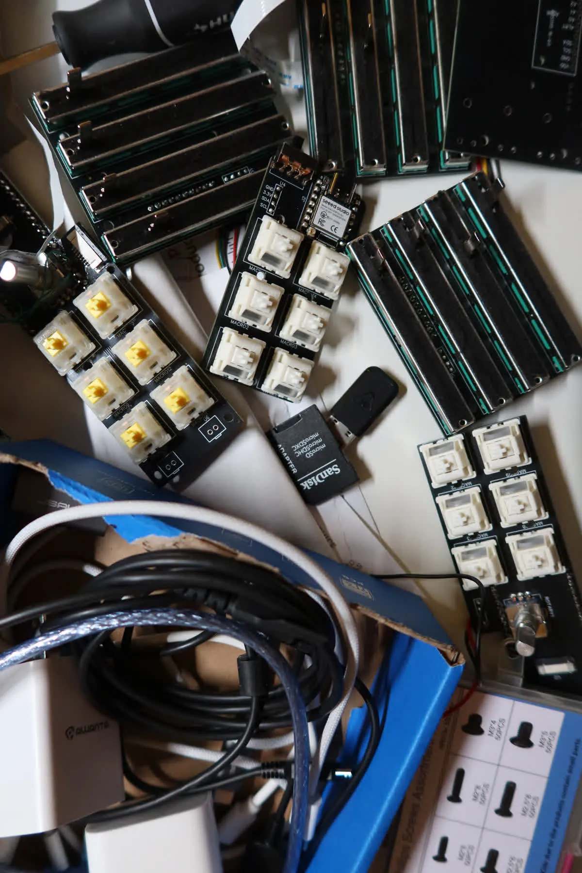 PCBs, switches, faders, and components on the workbench in Arizona
